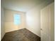 Cozy bedroom featuring wood-style ceramic tile and a window allowing natural light at 1147 Pomelo St, Davenport, FL 33837