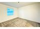 This bedroom features neutral paint, a window for natural light, and plush gray carpeting at 1147 Pomelo St, Davenport, FL 33837