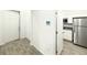 Welcoming entryway with ceramic tile flooring, leading to kitchen with stainless steel appliances at 1147 Pomelo St, Davenport, FL 33837