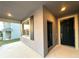 Inviting covered entryway featuring a black front door and window with stylish shutters at 1147 Pomelo St, Davenport, FL 33837