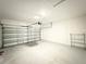 Spacious two-car garage with painted walls and floor offering ample storage and parking space at 1147 Pomelo St, Davenport, FL 33837
