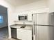 Modern kitchen featuring stainless steel appliances, granite countertops, and white cabinetry at 1147 Pomelo St, Davenport, FL 33837