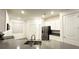 Bright kitchen with white cabinets, stainless steel appliances, and a gray countertop island at 1147 Pomelo St, Davenport, FL 33837