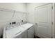 Dedicated laundry room with a modern washer, dryer, and wire shelving for storage at 1147 Pomelo St, Davenport, FL 33837