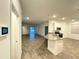 Open floorplan featuring wood-style floors connecting the kitchen to the living area at 1147 Pomelo St, Davenport, FL 33837
