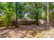 Large backyard featuring mature trees, partial shade, and a wooden fence for privacy at 116 E Plantation Blvd, Lake Mary, FL 32746