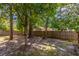 Shaded backyard with mature trees and wooden fence offering privacy at 116 E Plantation Blvd, Lake Mary, FL 32746