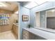 Bathroom vanity area with a large mirror and decorative floral accents at 116 E Plantation Blvd, Lake Mary, FL 32746
