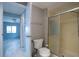 Bathroom featuring walk-in shower with a glass door, plus a toilet and open view to the bedroom at 116 E Plantation Blvd, Lake Mary, FL 32746