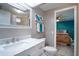 Bathroom features a vanity with drawers, a decorative mirror, and a toilet next to the sink at 116 E Plantation Blvd, Lake Mary, FL 32746