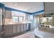 Bright kitchen features white cabinets, stainless appliances, white countertops, and gray wood-look floors at 116 E Plantation Blvd, Lake Mary, FL 32746