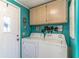Laundry room featuring matching washer and dryer, painted walls, and cabinets at 116 E Plantation Blvd, Lake Mary, FL 32746