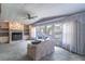 Bright living room featuring a stone fireplace, plush sofas, and large windows at 116 E Plantation Blvd, Lake Mary, FL 32746