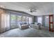 Bright living room with large windows, neutral decor, and comfortable seating at 116 E Plantation Blvd, Lake Mary, FL 32746