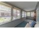 Enclosed sunroom with large windows, blue carpeting, and a comfortable seating area at 116 E Plantation Blvd, Lake Mary, FL 32746