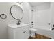 Bathroom features a vanity, round mirror, and combined tub and shower at 1235 Arapaho Trl, Geneva, FL 32732