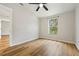 Bright bedroom features wood floors and a window showcasing the outdoor trees at 1235 Arapaho Trl, Geneva, FL 32732