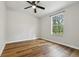 A calm bedroom with wood flooring and a window that offers outdoor views at 1235 Arapaho Trl, Geneva, FL 32732