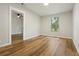 An inviting bedroom features wood-look floors and a bright window view at 1235 Arapaho Trl, Geneva, FL 32732