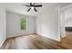 Well-lit bedroom features ceiling fan, laminate wood flooring, and a large window at 1235 Arapaho Trl, Geneva, FL 32732