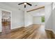 Living room showcases hardwood flooring and views into the open concept kitchen and dining area at 1235 Arapaho Trl, Geneva, FL 32732