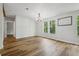 Light-filled room with wood floors and multiple windows offering views of the surrounding greenery at 1235 Arapaho Trl, Geneva, FL 32732