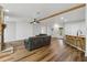 Comfortable living area featuring wood floors, breakfast bar, shiplap accent wall and a stone fireplace at 1235 Arapaho Trl, Geneva, FL 32732