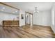 Bright living space featuring wood floors, an open floorplan, breakfast bar, and ample natural light at 1235 Arapaho Trl, Geneva, FL 32732