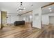 Bright living area boasts a stone fireplace, wood beams, and seamlessly connects to other spaces at 1235 Arapaho Trl, Geneva, FL 32732