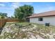 A fenced backyard with a unique concrete bench and fire pit area for outdoor enjoyment at 1353 Ortega St, Winter Springs, FL 32708