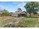 Exterior view of the home showcasing a screened-in porch and wooden fencing at 1353 Ortega St, Winter Springs, FL 32708