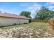 A fully fenced backyard with grass and sandy patches, offering privacy at 1353 Ortega St, Winter Springs, FL 32708