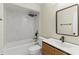 Bathroom showcasing shower-tub combination with designer tile surround, modern vanity, and dark fixtures at 1353 Ortega St, Winter Springs, FL 32708