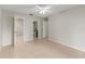 Spacious bedroom features neutral walls, ceiling fan, tiled floors, and ensuite bathroom at 1353 Ortega St, Winter Springs, FL 32708