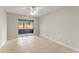 Bright bedroom offers neutral walls, ceiling fan, and sliding glass doors to the screened porch at 1353 Ortega St, Winter Springs, FL 32708