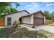 Single-Gathering home featuring stone accents, a two-car garage, and a manicured front yard at 1353 Ortega St, Winter Springs, FL 32708