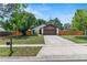 Well-maintained single-Gathering home featuring stone accents, a two-car garage, and a well-manicured lawn at 1353 Ortega St, Winter Springs, FL 32708