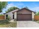Charming single-Gathering home featuring stone accents, a two-car garage, and a well-manicured front yard at 1353 Ortega St, Winter Springs, FL 32708