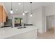 Modern kitchen features a sleek island with pendant lighting and stainless steel appliances at 1353 Ortega St, Winter Springs, FL 32708