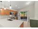 Bright kitchen with stainless steel appliances, white countertops, and a view of the screened in patio at 1353 Ortega St, Winter Springs, FL 32708