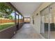 A screened porch with view of the fenced backyard at 1353 Ortega St, Winter Springs, FL 32708