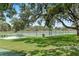 A fenced tennis court available for residents, surrounded by picnic tables at 1353 Ortega St, Winter Springs, FL 32708