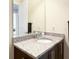 Bathroom featuring granite countertop, sink, faucet, mirror, and dark cabinets at 13755 Benavente Ave, Orlando, FL 32827