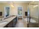 Bathroom with double vanity, large mirror and separate shower and tub at 13755 Benavente Ave, Orlando, FL 32827