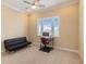 Bright bedroom with a futon, desk, and a window overlooking the neighborhood at 13755 Benavente Ave, Orlando, FL 32827