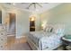 Spacious bedroom with a ceiling fan, dresser, and access to bathroom and stairs at 13755 Benavente Ave, Orlando, FL 32827
