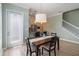 Cozy dining space adjoins to the kitchen, with contemporary table set and bright natural light at 13755 Benavente Ave, Orlando, FL 32827