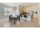Modern dining area with an open concept to the kitchen and contemporary light fixtures and finishes at 13755 Benavente Ave, Orlando, FL 32827