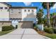Multi-story townhome featuring an attached garage, neutral color palette and manicured landscaping at 13755 Benavente Ave, Orlando, FL 32827