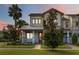 Attractive two-story house with a well-maintained lawn, a palm tree, and a welcoming front porch at 13755 Benavente Ave, Orlando, FL 32827